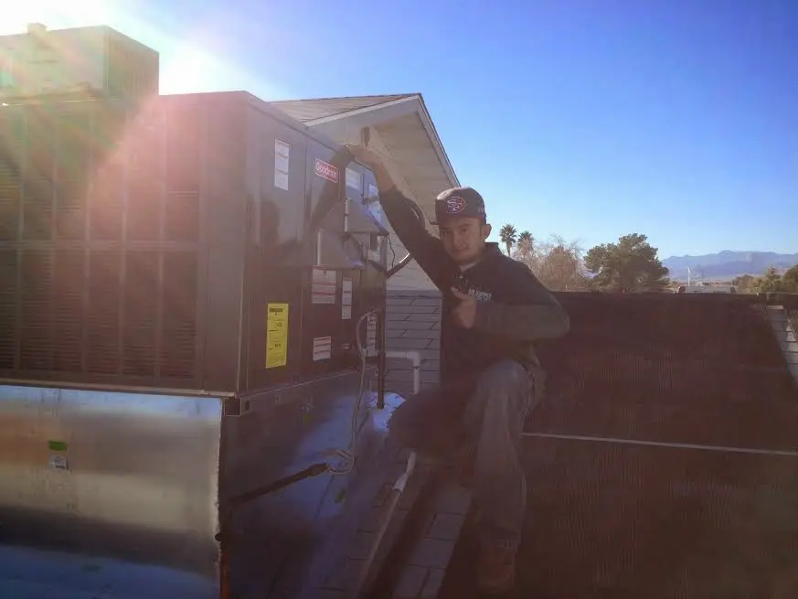 HVAC technician performing HVAC Inspection on a rooftop unit in Seneca Falls